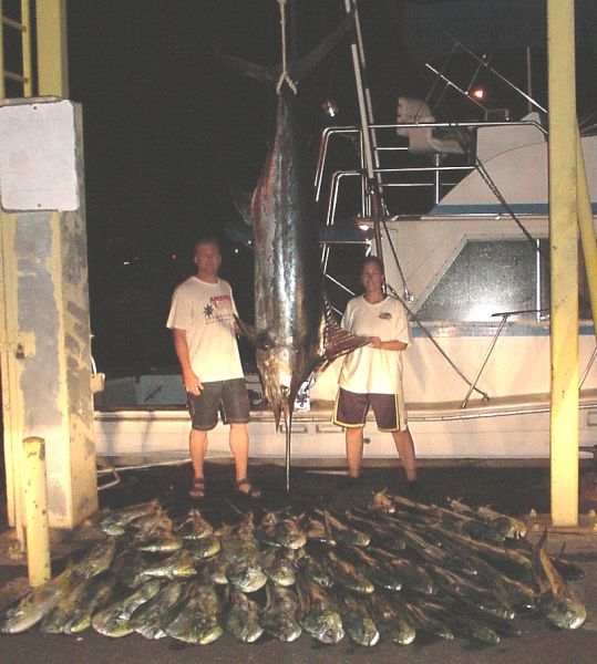 4-30-04
Dave and Tammi just wanted to go out and catch a few little fish. So we did, sort of. After 47 Mahi Mahi for a little over 900 pounds it was time to head for home. Then mean old Mr. Marlin showed up. So we caught him too. So that's 900 pounds of Mahi Mahi and a 500 pound Marlin. Just a few little fish- REALLY! Dave and Tammi are awesome anglers and two of the nicest people we've fished with in a long time. Now this was a super day!
